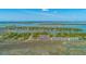 Scenic aerial view of waterfront homes surrounded by lush greenery and natural marshlands at 221 E Mariners Cay # 221, Folly Beach, SC 29439