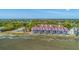 Aerial shot displaying waterfront townhomes with scenic marshland views and mature trees at 221 E Mariners Cay # 221, Folly Beach, SC 29439
