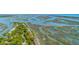 Aerial view showcasing waterfront properties with private docks along winding waterways and marshland at 221 E Mariners Cay # 221, Folly Beach, SC 29439