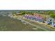 Scenic aerial view of waterfront townhomes with a unique roof design and marshland surroundings at 221 E Mariners Cay # 221, Folly Beach, SC 29439