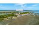 Scenic aerial view of 221 E Mariners Cay homes among lush trees, tennis courts, and serene marshlands at 221 E Mariners Cay # 221, Folly Beach, SC 29439