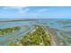 Aerial view of waterfront homes surrounded by marshes and waterways under a bright blue sky at 221 E Mariners Cay # 221, Folly Beach, SC 29439