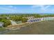 Aerial view showcasing waterfront townhomes with scenic views and a community tennis court at 221 E Mariners Cay # 221, Folly Beach, SC 29439