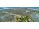 Attractive aerial view capturing marshland and waterways leading up to waterfront homes and a scenic coastal road at 221 E Mariners Cay # 221, Folly Beach, SC 29439