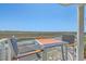 Cozy balcony seating area with marsh views, creating a perfect spot to unwind and appreciate the peaceful scenery at 221 E Mariners Cay # 221, Folly Beach, SC 29439