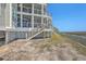 Back of charming coastal home with elevated design providing marsh views from the decks at 221 E Mariners Cay # 221, Folly Beach, SC 29439