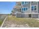 Charming coastal home with elevated design providing marsh views from the balconies at 221 E Mariners Cay # 221, Folly Beach, SC 29439