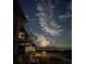 Night exterior view of the condo with balconies overlooking the waterfront at 221 E Mariners Cay # 221, Folly Beach, SC 29439