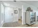 Inviting foyer with white door, neutral rug, cabinet and coastal decor at 221 E Mariners Cay # 221, Folly Beach, SC 29439