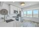 Bright kitchen featuring white cabinets, quartz countertops, stainless steel appliances, and marsh views at 221 E Mariners Cay # 221, Folly Beach, SC 29439