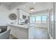 Bright kitchen features white cabinetry, stainless steel appliances, and scenic views at 221 E Mariners Cay # 221, Folly Beach, SC 29439