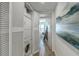 Compact laundry area featuring a stackable washer and dryer with built-in shelving for storage at 221 E Mariners Cay # 221, Folly Beach, SC 29439
