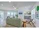 Open living room with modern furnishings, bar area, and sliding glass doors to the marsh at 221 E Mariners Cay # 221, Folly Beach, SC 29439