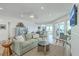 Bright and cozy living room with access to the kitchen and outdoor seating area at 221 E Mariners Cay # 221, Folly Beach, SC 29439