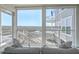 Bright living area with marsh views, showcasing comfortable seating and a serene indoor-outdoor connection at 221 E Mariners Cay # 221, Folly Beach, SC 29439