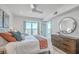 Bright main bedroom featuring large window and natural light, wood dresser and a king sized bed at 221 E Mariners Cay # 221, Folly Beach, SC 29439