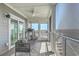 Inviting screened porch features comfortable seating, ceiling fan, and views of the marsh at 221 E Mariners Cay # 221, Folly Beach, SC 29439