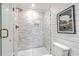 Close-up of modern shower stall with white subway tile and glass door at 221 E Mariners Cay # 221, Folly Beach, SC 29439