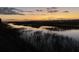 Beautiful sunset view of the marsh from the property, reflecting in the tranquil water at 221 E Mariners Cay # 221, Folly Beach, SC 29439