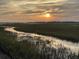 Amazing sunset view with sunbeams over the marsh landscape reflecting off the water at 221 E Mariners Cay # 221, Folly Beach, SC 29439