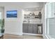 Stylish wet bar with shelving, a wine fridge and sink for easy entertaining at 221 E Mariners Cay # 221, Folly Beach, SC 29439