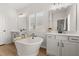 Bright bathroom features a soaking tub, wood floors, and double sinks at 226 Midtown Ave, Summerville, SC 29486