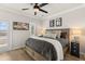 Cozy bedroom with natural light, ceiling fan, and a comfortable bed with stylish pillows and blankets at 226 Midtown Ave, Summerville, SC 29486