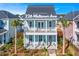 Charming two-story coastal home with dual porches, lush landscaping and inviting curb appeal in Nexton Midtown at 226 Midtown Ave, Summerville, SC 29486