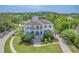 Beautiful aerial view of a two-story home with double porches, driveway, and lush landscaping at 2269 Hartfords Bluff Cir, Mount Pleasant, SC 29466