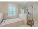 Bright bathroom featuring a large walk-in shower, soaking tub, and tiled walls at 2269 Hartfords Bluff Cir, Mount Pleasant, SC 29466