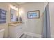 Well-lit bathroom featuring a vanity with a marble countertop, modern fixtures, and decorative art at 2269 Hartfords Bluff Cir, Mount Pleasant, SC 29466