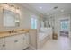 Large main bathroom with soaking tub, walk-in shower, and marble countertops at 2269 Hartfords Bluff Cir, Mount Pleasant, SC 29466