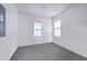 Bright, carpeted bedroom features two windows, fresh white walls and a modern ceiling light at 2269 Hartfords Bluff Cir, Mount Pleasant, SC 29466