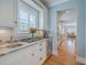 Butler's Pantry with custom cabinets, stone counters, wine fridge, and beverage center at 2269 Hartfords Bluff Cir, Mount Pleasant, SC 29466