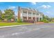 Attractive clubhouse featuring white columns, dormer windows, and manicured landscaping at 2269 Hartfords Bluff Cir, Mount Pleasant, SC 29466