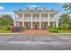 Elegant clubhouse boasts a symmetrical facade with a colonnade porch and brick-paved walkway at 2269 Hartfords Bluff Cir, Mount Pleasant, SC 29466