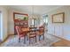 Well-lit dining room with hardwood floors, decorative rug, and elegant decor at 2269 Hartfords Bluff Cir, Mount Pleasant, SC 29466