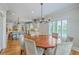 This dining room features a round table, seating for six, and a view of the kitchen at 2269 Hartfords Bluff Cir, Mount Pleasant, SC 29466