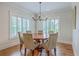 Bright dining room features a round table, six chairs, hardwood floors, and white plantation shutters at 2269 Hartfords Bluff Cir, Mount Pleasant, SC 29466
