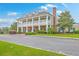 Grand two-story clubhouse featuring a colonnade porch, brick facade, and mature landscaping at 2269 Hartfords Bluff Cir, Mount Pleasant, SC 29466