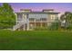 Beautiful home exterior with a large lawn, screened porch, white stairs, and manicured landscaping at 2269 Hartfords Bluff Cir, Mount Pleasant, SC 29466