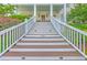 Inviting front entrance with stairs leading to a charming porch, showcasing curb appeal at 2269 Hartfords Bluff Cir, Mount Pleasant, SC 29466