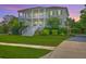Beautiful two-story home with inviting front porch, lush lawn, and manicured landscaping at 2269 Hartfords Bluff Cir, Mount Pleasant, SC 29466