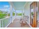 Charming front porch with a swing, wooden chairs, and scenic views of the neighborhood at 2269 Hartfords Bluff Cir, Mount Pleasant, SC 29466