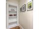 Hallway featuring built-in shelving, stylish art, and warm wood floors, adds character at 2269 Hartfords Bluff Cir, Mount Pleasant, SC 29466