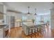 Spacious kitchen with stainless steel appliances, a large island, and a dining area in the background at 2269 Hartfords Bluff Cir, Mount Pleasant, SC 29466