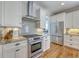 Modern kitchen with stainless steel appliances, granite countertops, and white cabinetry at 2269 Hartfords Bluff Cir, Mount Pleasant, SC 29466