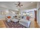 Open living space with hardwood floors, a ceiling fan, and views of the kitchen and staircase at 2269 Hartfords Bluff Cir, Mount Pleasant, SC 29466