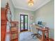 Stylish office features a hardwood desk, ornate wooden cabinet, and doors to a balcony at 2269 Hartfords Bluff Cir, Mount Pleasant, SC 29466