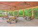 Community picnic area with wooden picnic tables under a covered wooden structure with ceiling fans at 2269 Hartfords Bluff Cir, Mount Pleasant, SC 29466
